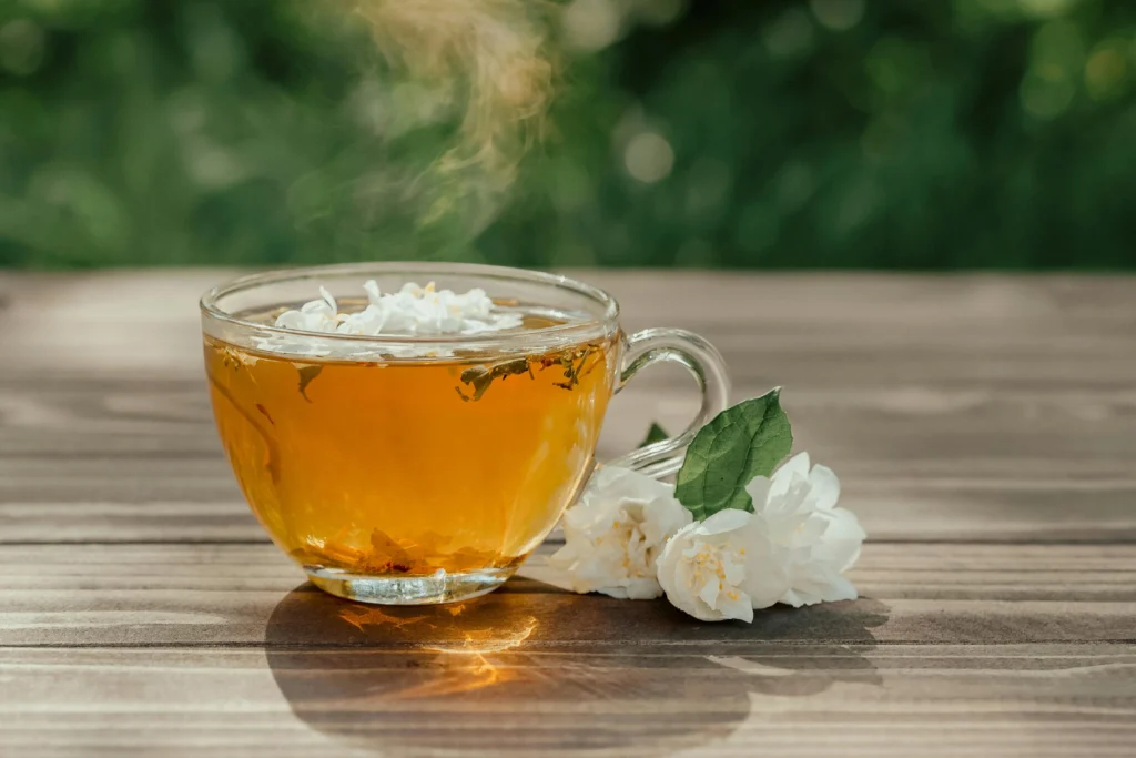 Jasmine tea Jasmine tea in traditional cup with fresh jasmine flowers